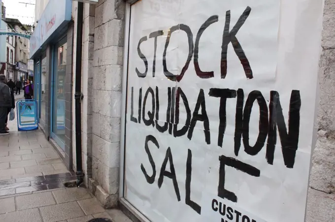 Stock liquidation sale written on shop window in bangor north wales great britain uk