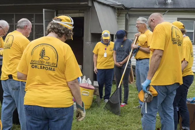 Houston, Texas - Oklahoma volunteers from the Southern Baptist Convention pray with a resident after helping clean her home. The home was flooded when...