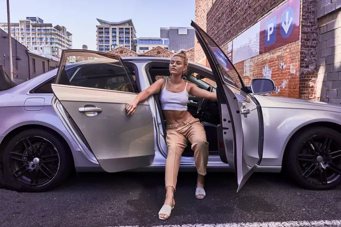 Australia, Adelaide, women fashion blogger and actress Sarah Jeavons posing in parked car