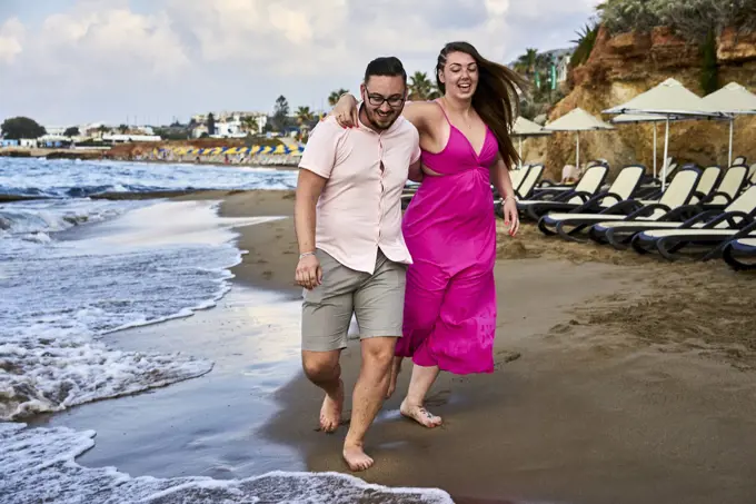 Chersonissos, Crete, Greece, couple walking on beach, vacations