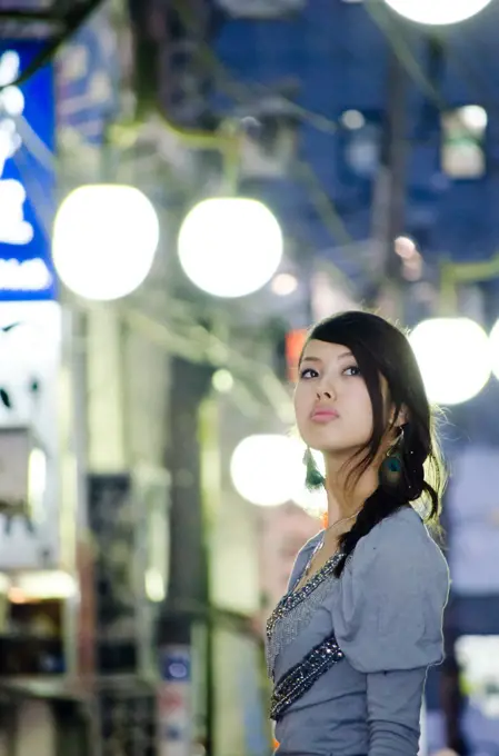 Japanese Girl poses on the street in Nakameguro, Japan. Nakameguro is a town located in the nice area of Tokyo.