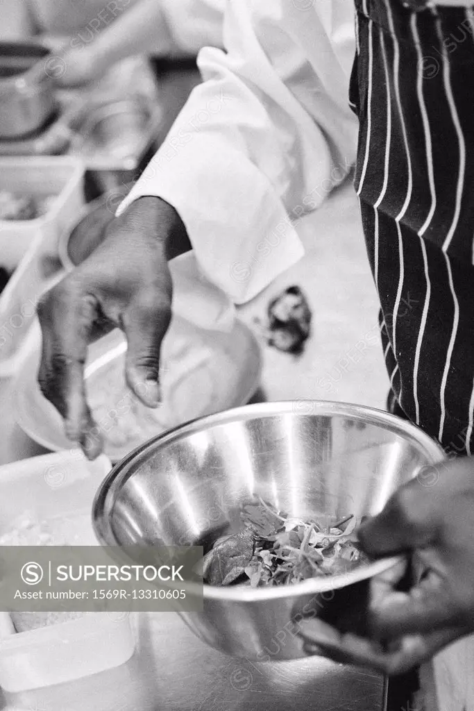 Chef preparing food in mixing bowl