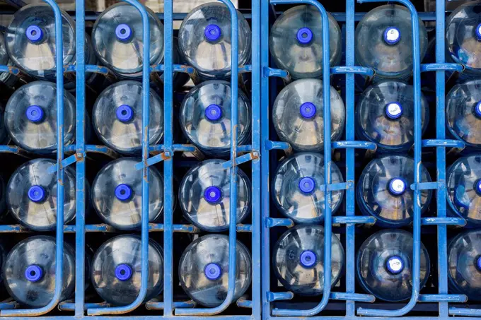 Rows of water bottles arranged in warehouse