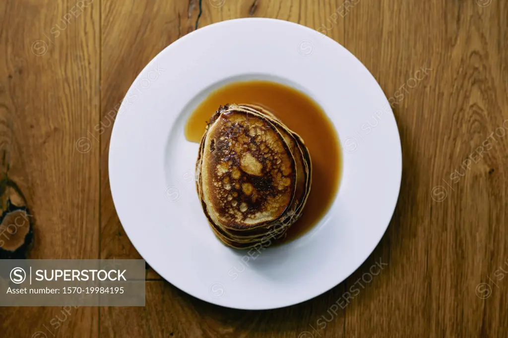 Still life stack of pancakes with maple syrup on plate