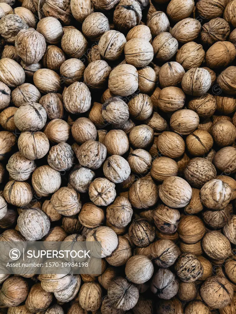 Close up full frame brown walnuts in shells