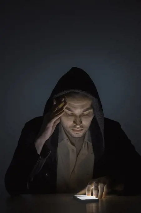 Man using smart phone in dark