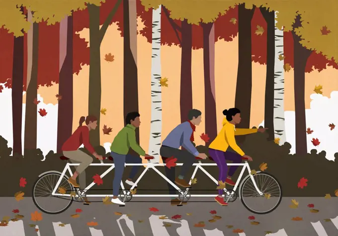 Friends riding tandem bicycle in autumn park
