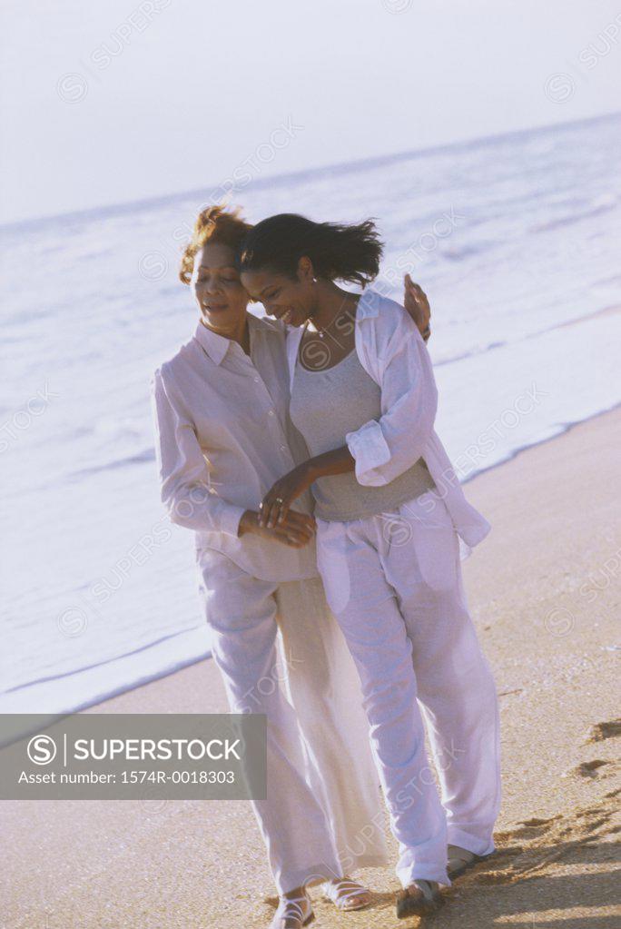 Stock Photo: 1574R-0018303 Mother walking with her daughter on the beach