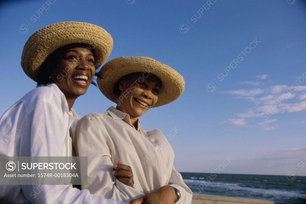 Stock Photo: 1574R-0018304A Close-up of a mother and daughter smiling on the beach