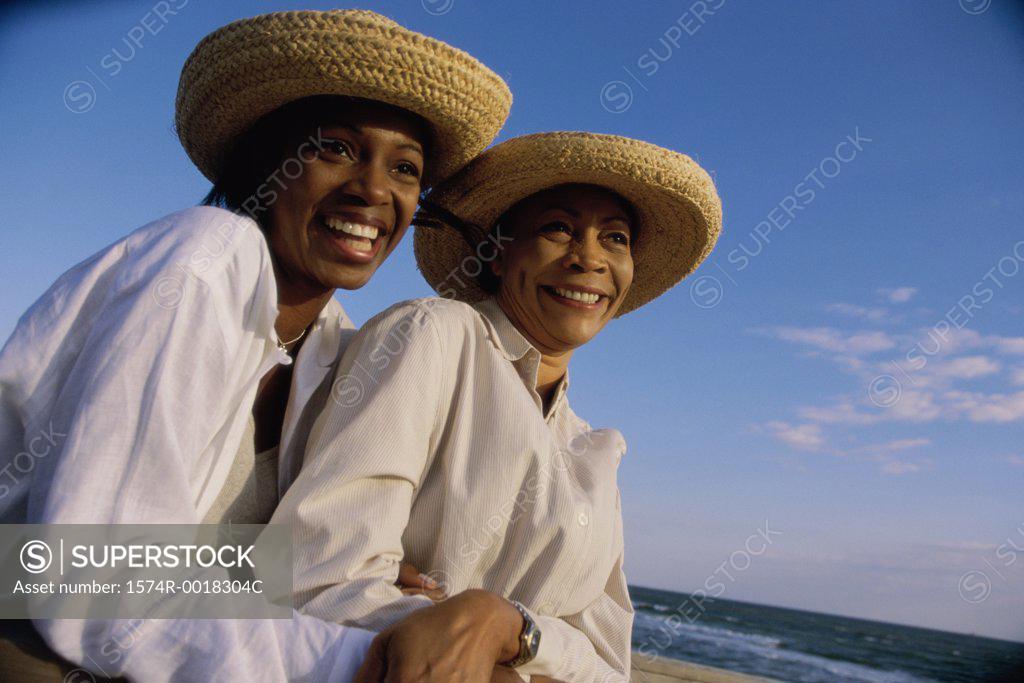 Stock Photo: 1574R-0018304C Close-up of a mother and daughter smiling on the beach