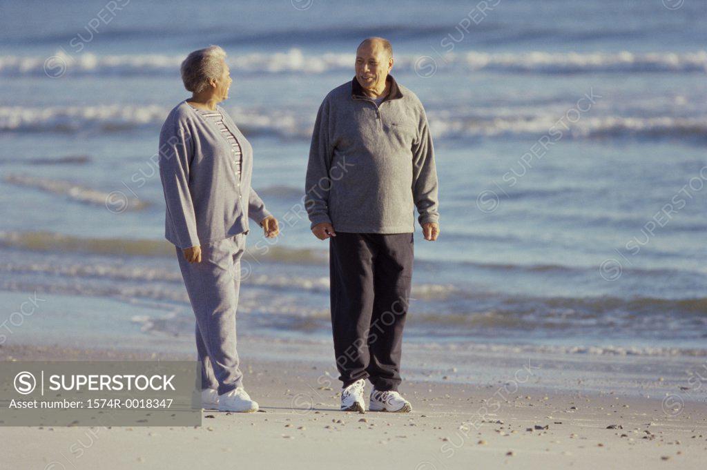 Stock Photo: 1574R-0018347 Senior couple standing on the beach