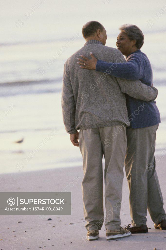 Stock Photo: 1574R-0018349 Rear view of a senior couple standing on the beach