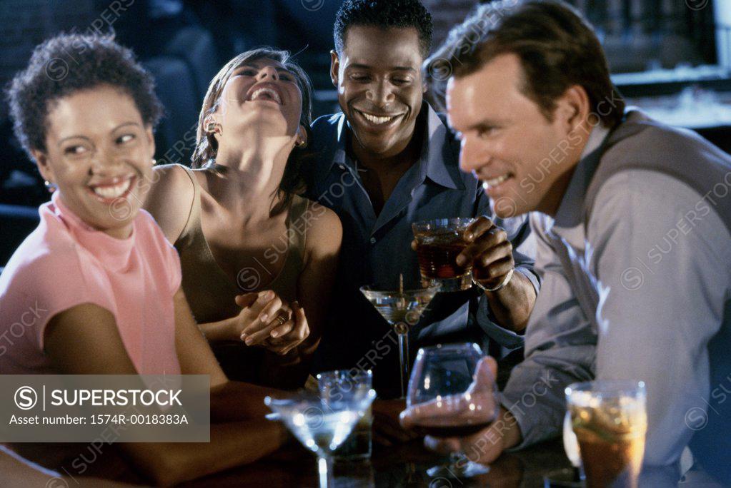 Stock Photo: 1574R-0018383A Two young couples together in a bar