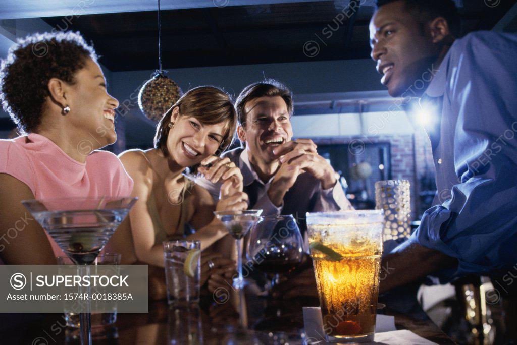Stock Photo: 1574R-0018385A Two young couples together in a bar