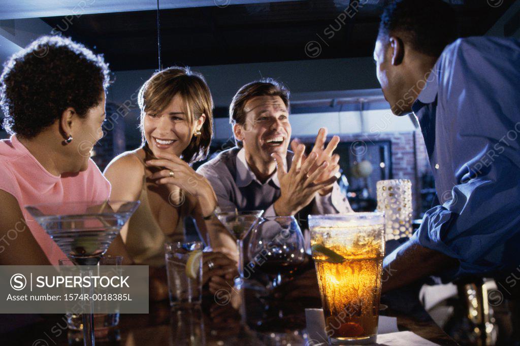 Stock Photo: 1574R-0018385L Two young couples together in a bar