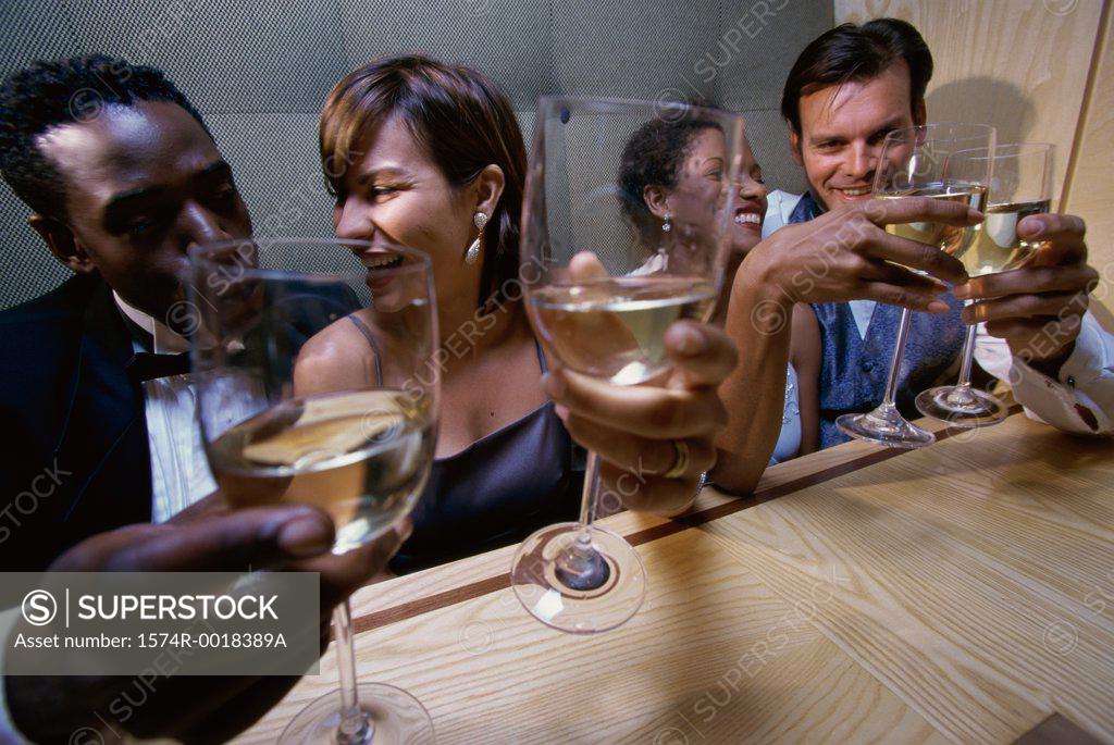 Stock Photo: 1574R-0018389A High angle view of two young couples toasting with wineglasses
