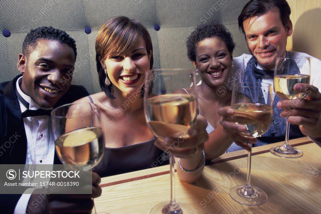 Stock Photo: 1574R-0018390 Portrait of two young couples toasting with wineglasses