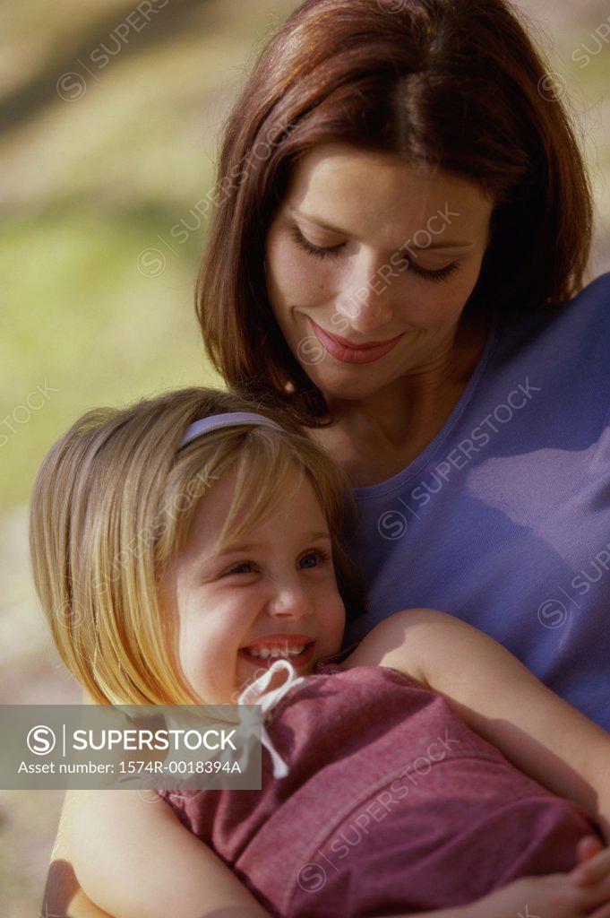 Stock Photo: 1574R-0018394A Close-up of a daughter sitting on her mother's lap