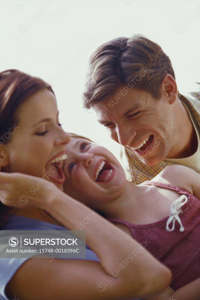 Stock Photo: 1574R-0018396C Close-up of parents and their daughter laughing