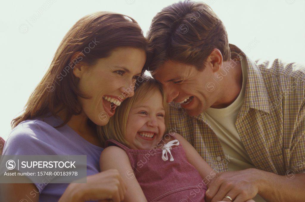 Stock Photo: 1574R-0018397B Close-up of parents and their daughter laughing
