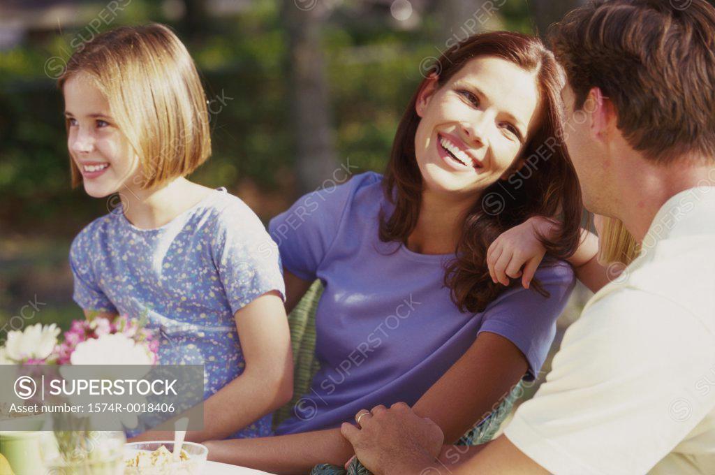 Stock Photo: 1574R-0018406 Parents sitting with their two daughters and smiling