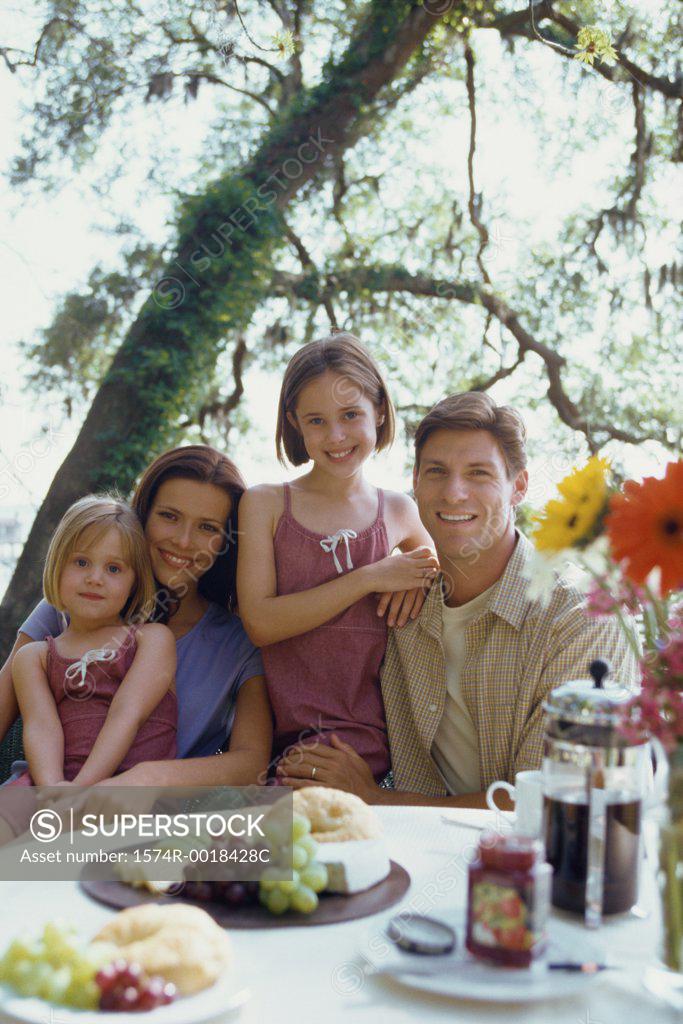 Stock Photo: 1574R-0018428C Portrait of parents with their two daughters smiling