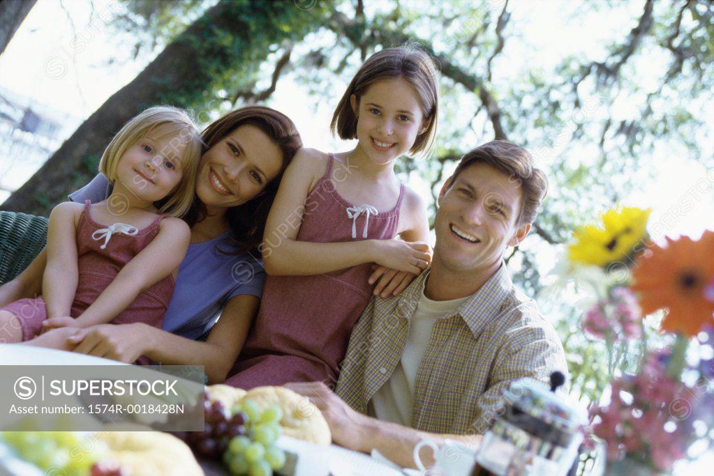 Stock Photo: 1574R-0018428N Portrait of parents with their two daughters smiling