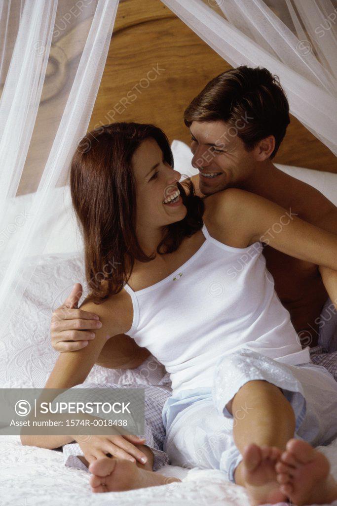 Stock Photo: 1574R-0018438 High angle view of a young couple sitting on a bed