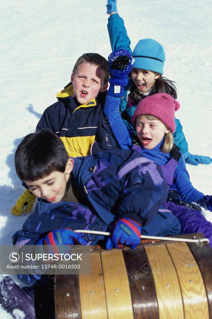 Stock Photo: 1574R-0018503 High angle view of two boys and two girls riding on a sled