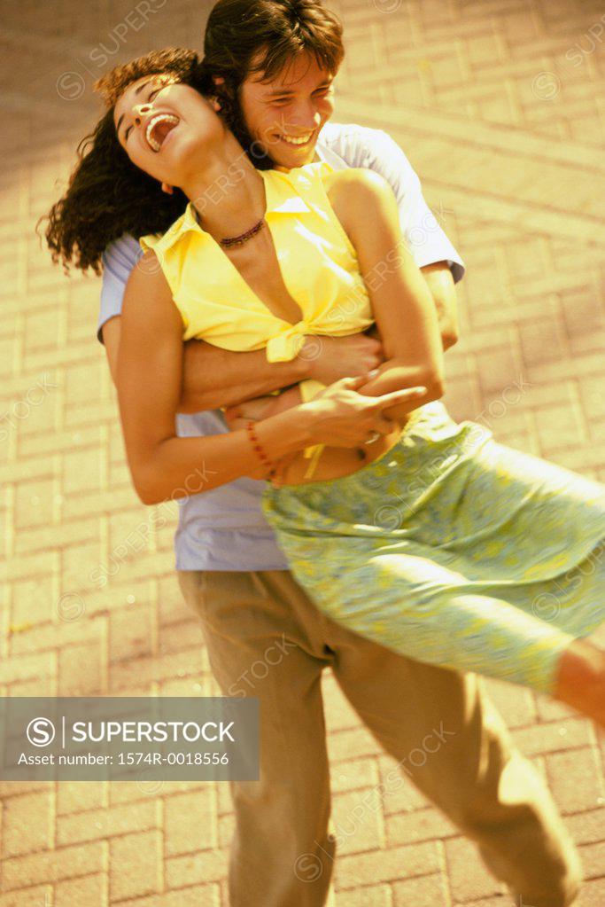 Stock Photo: 1574R-0018556 High angle view of a young man lifting a young woman