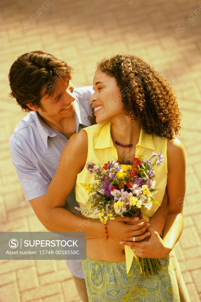 Stock Photo: 1574R-0018558C High angle view of a young man embracing a teenage girl from behind