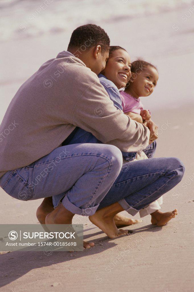 Stock Photo: 1574R-0018569B Parents with their daughter on the beach