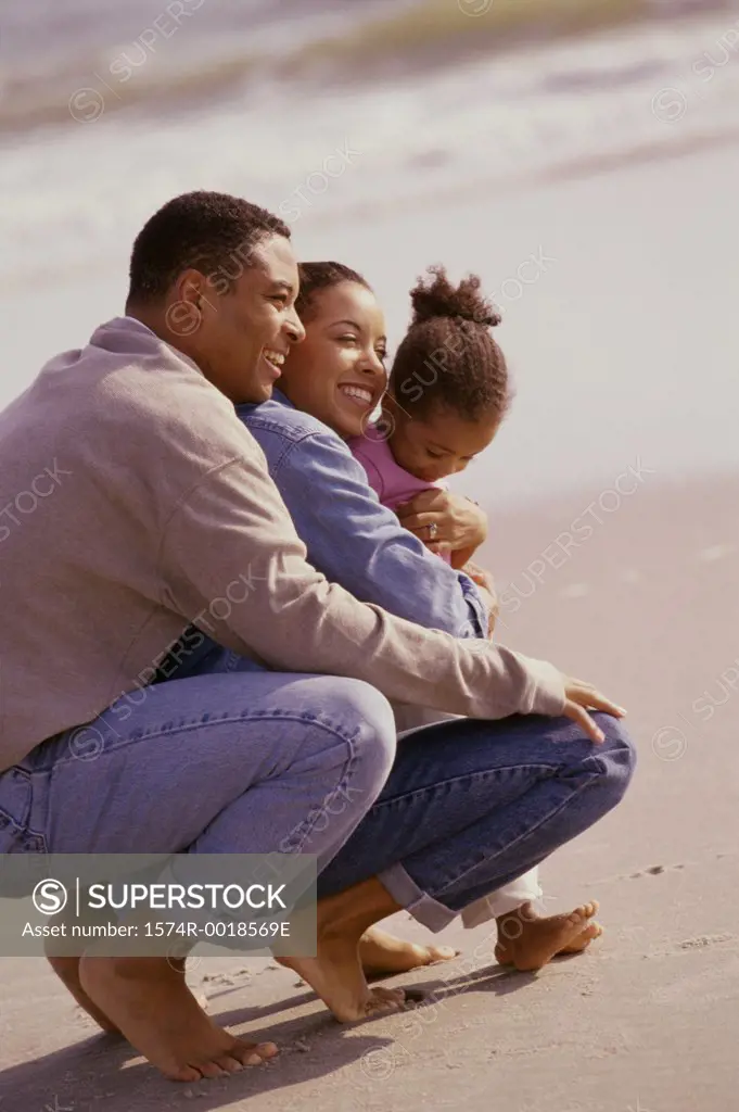 Parents with their daughter on the beach
