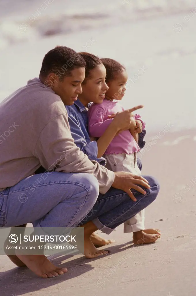 Parents with their daughter on the beach