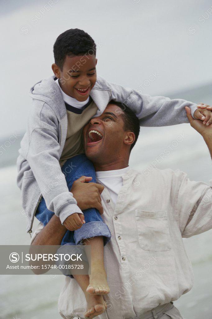 Stock Photo: 1574R-0018572B Father carrying his son on his shoulders