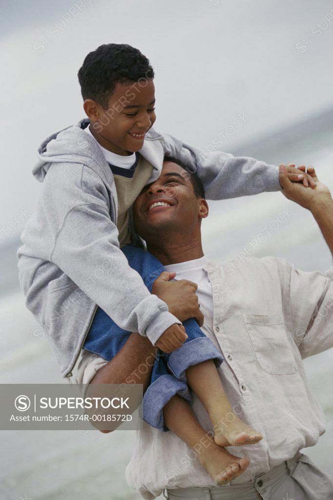 Stock Photo: 1574R-0018572D Father carrying his son on his shoulders
