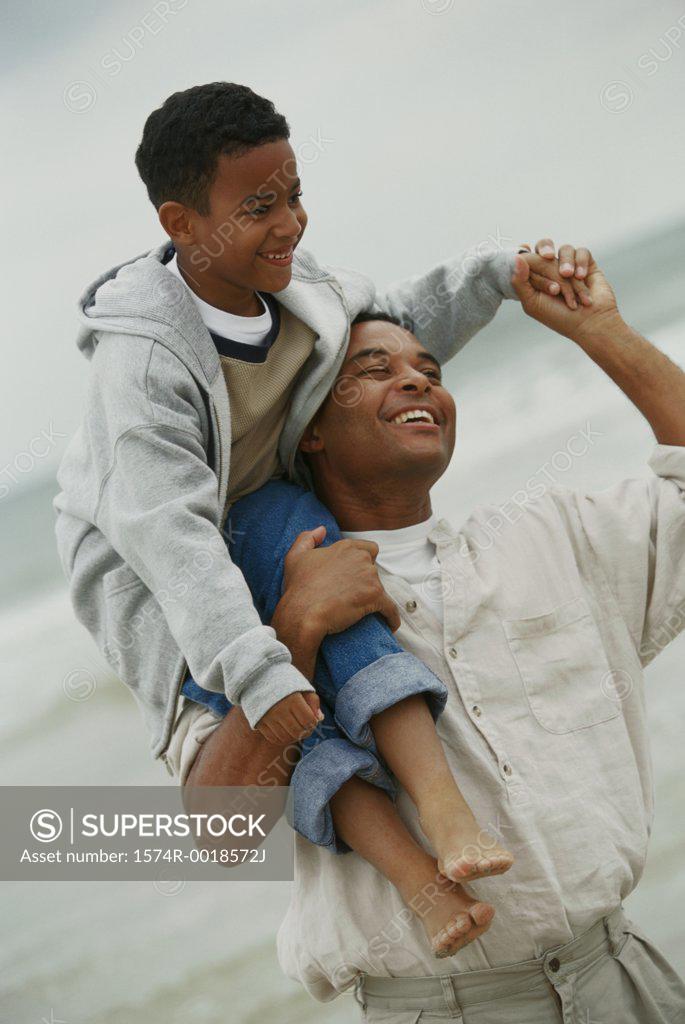 Stock Photo: 1574R-0018572J Father carrying his son on his shoulders