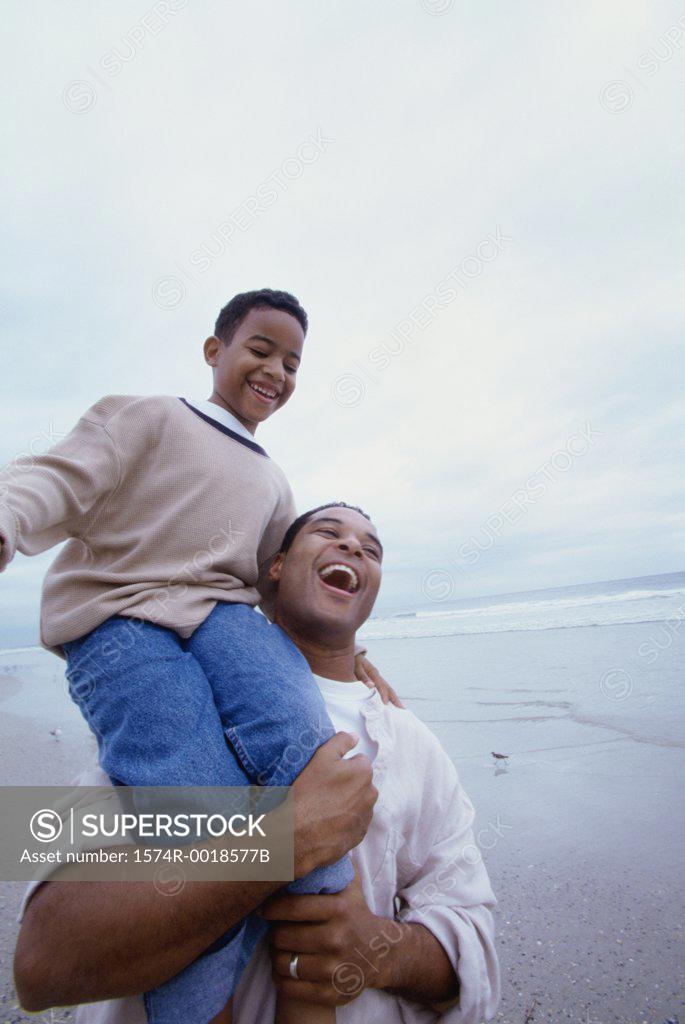 Stock Photo: 1574R-0018577B Father carrying his son on his shoulders