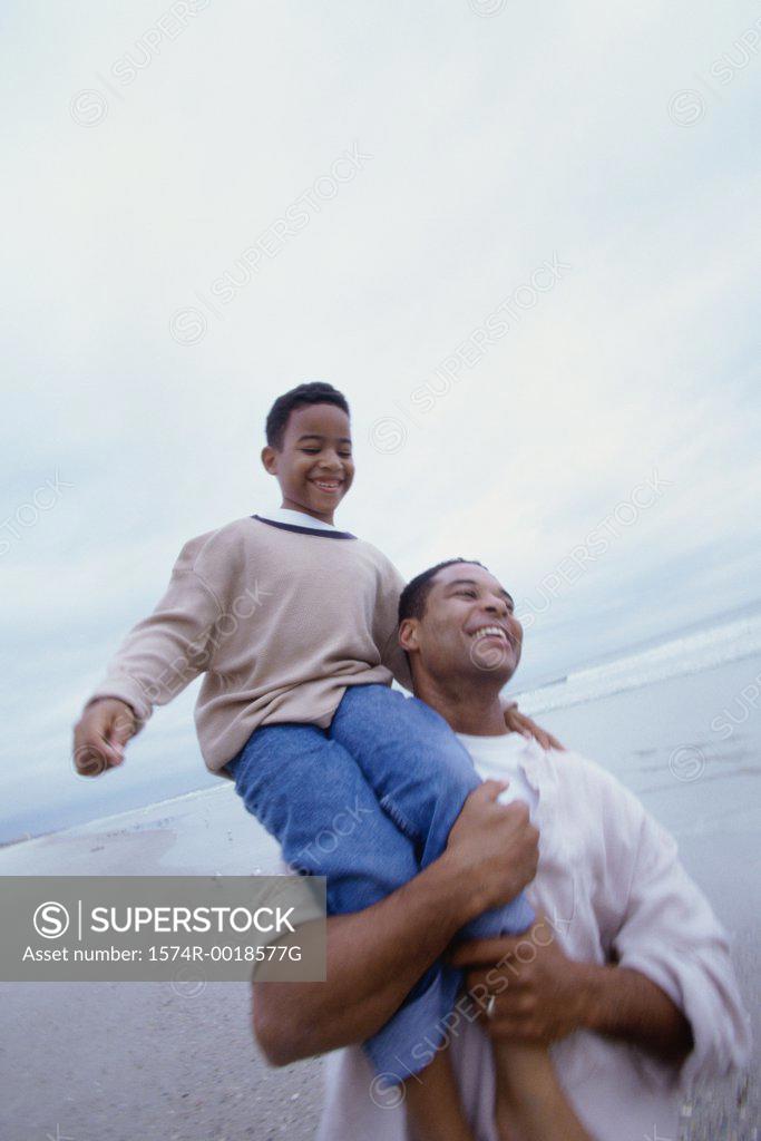 Stock Photo: 1574R-0018577G Father carrying his son on his shoulders