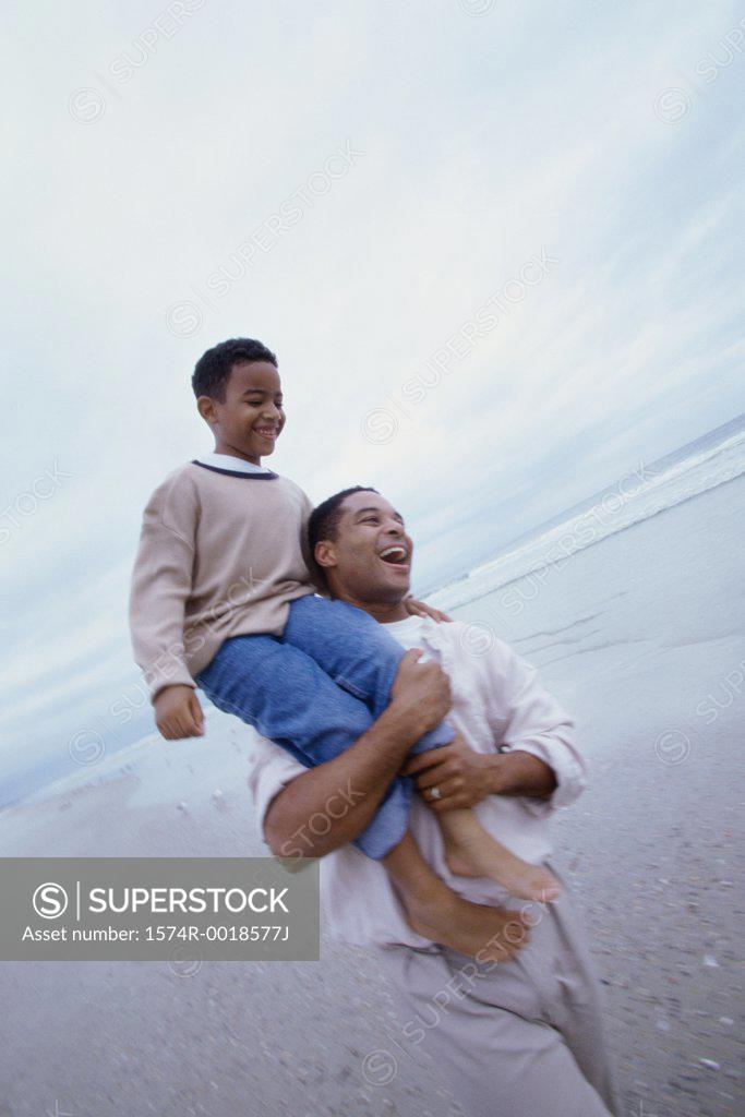 Stock Photo: 1574R-0018577J Father carrying his son on his shoulders