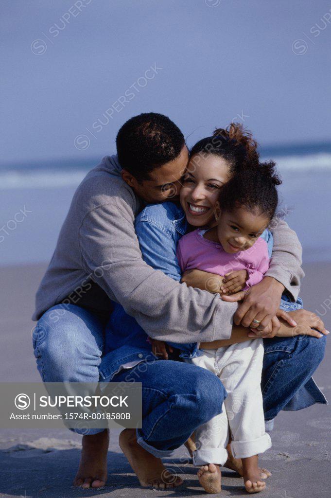 Stock Photo: 1574R-0018580B Parents with their daughter on the beach