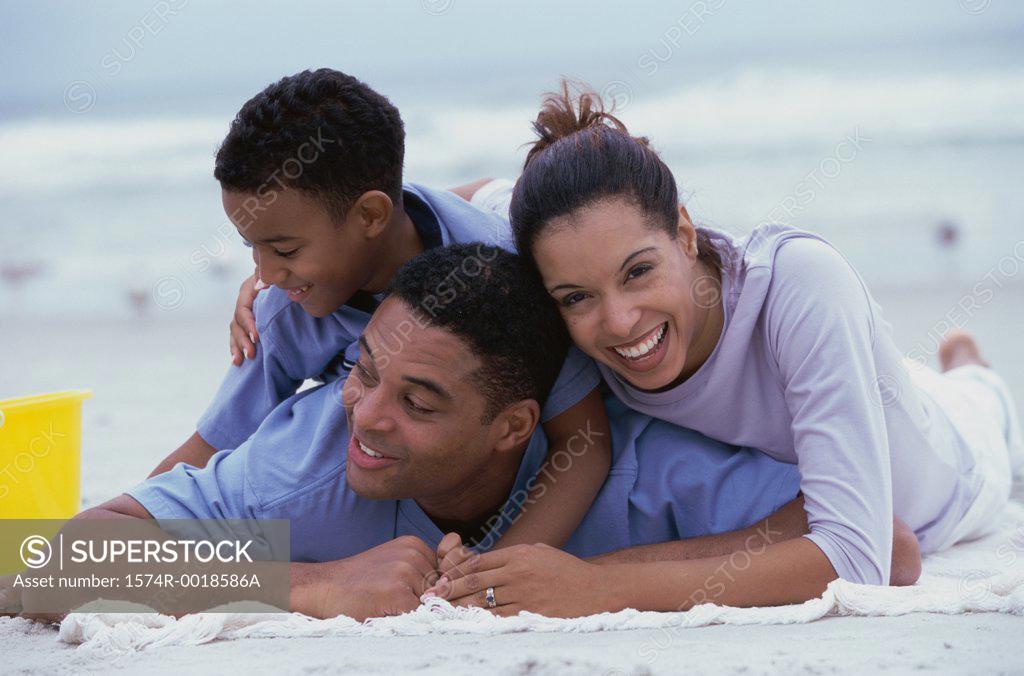 Stock Photo: 1574R-0018586A Close-up of parents and their son smiling on the beach