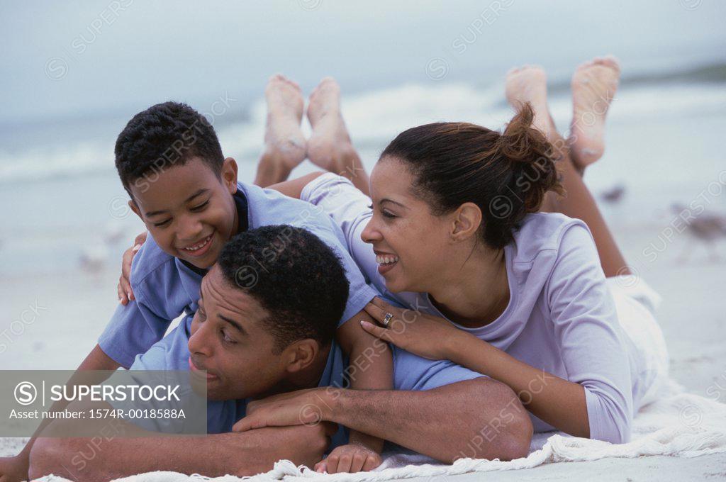 Stock Photo: 1574R-0018588A Close-up of parents and their son smiling on the beach