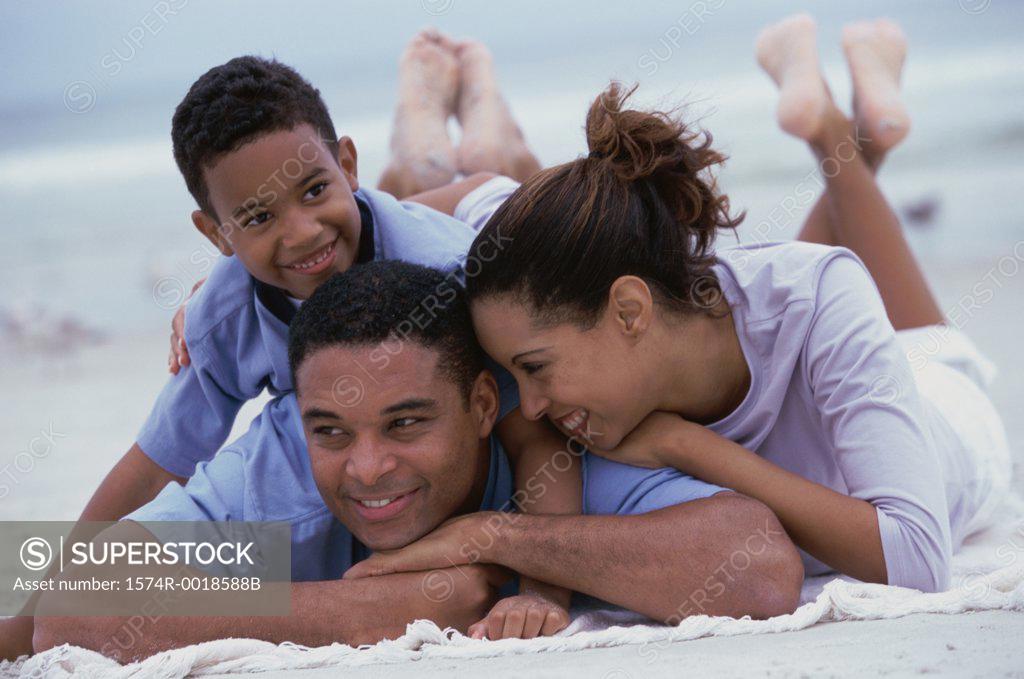 Stock Photo: 1574R-0018588B Close-up of parents smiling with their son on the beach