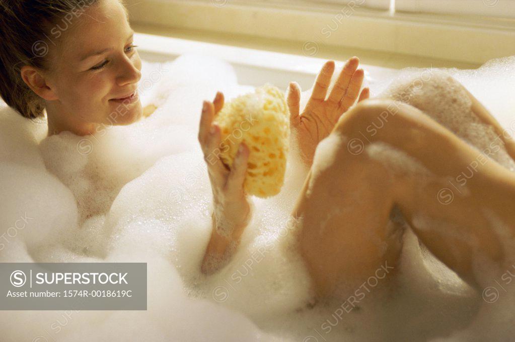 Stock Photo: 1574R-0018619C High angle view of a young woman in a bathtub