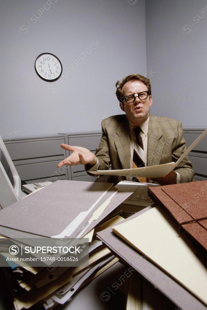 Stock Photo: 1574R-0018626 Portrait of a businessman holding a file