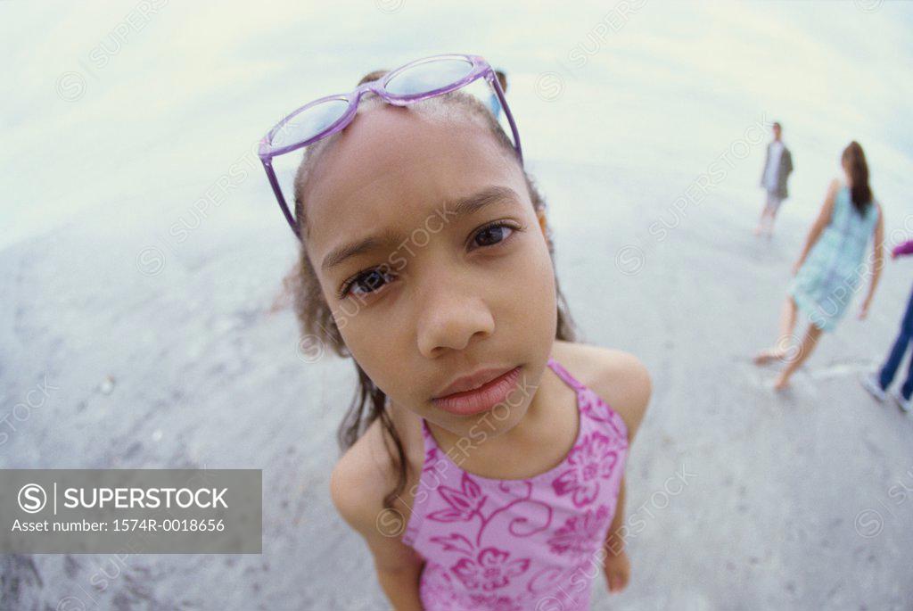 Stock Photo: 1574R-0018656 Portrait of a girl standing on the beach