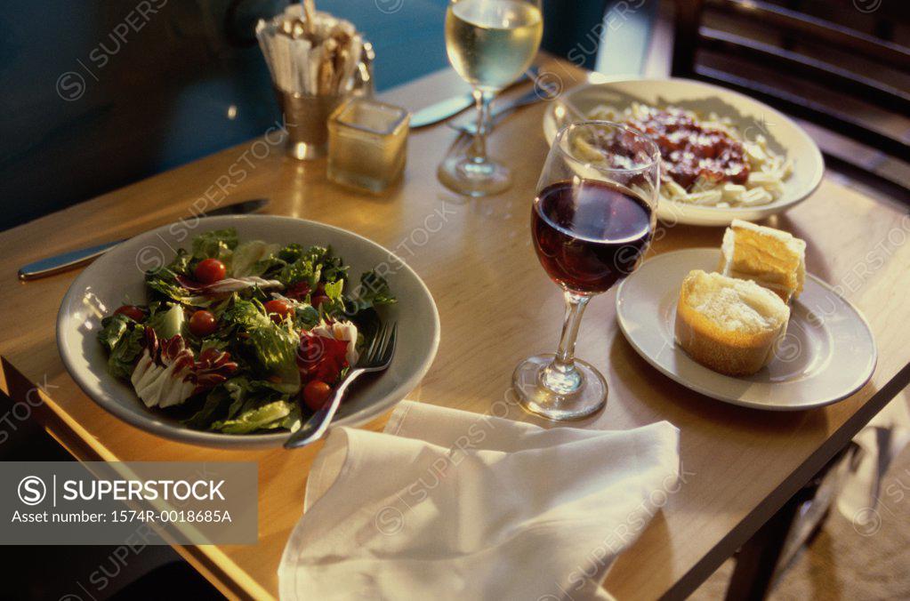 Stock Photo: 1574R-0018685A Close-up of food with two glasses of wine on a table