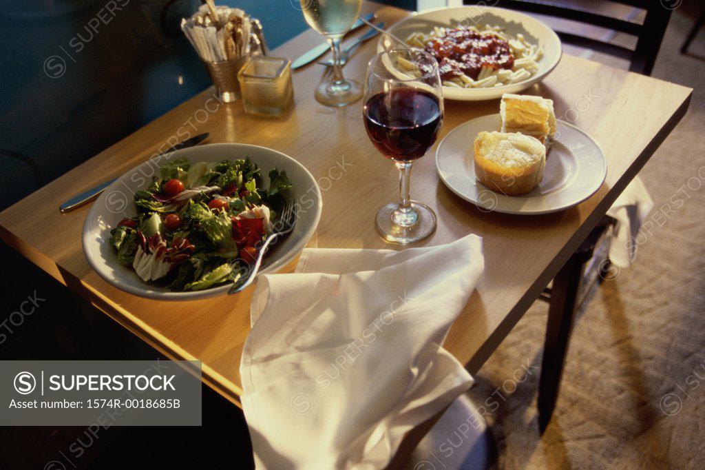 Stock Photo: 1574R-0018685B Close-up of food with two glasses of wine on a table