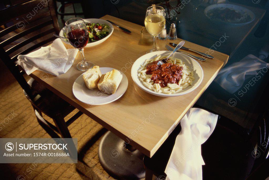 Stock Photo: 1574R-0018686A High angle view of food with two glasses of wine on a table
